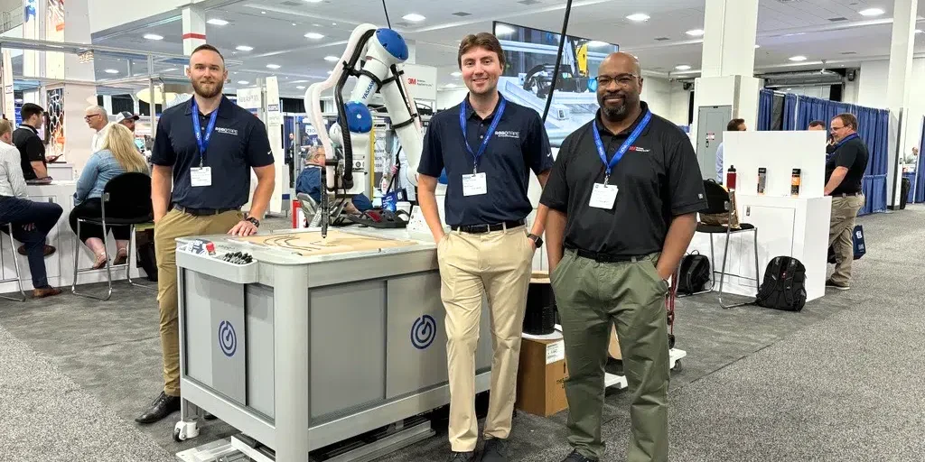 3M and RoboTape team in front of RoboTape 3M Taping Machine.
